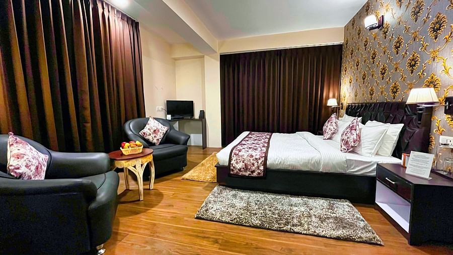 Dream Villa Retreat, Pelling - The comfortable bedding with a bed runner, two sofa chairs and the luxurious interiors of the Deluxe Rooms