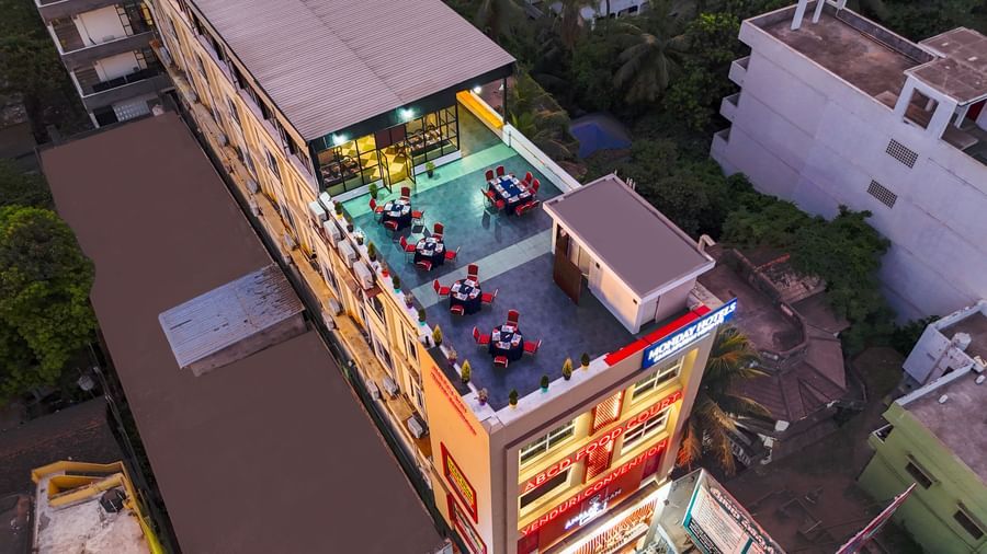 Aerial rooftop view of Monday Hotels Amalapuram Heights with spacious rooftop dining area.