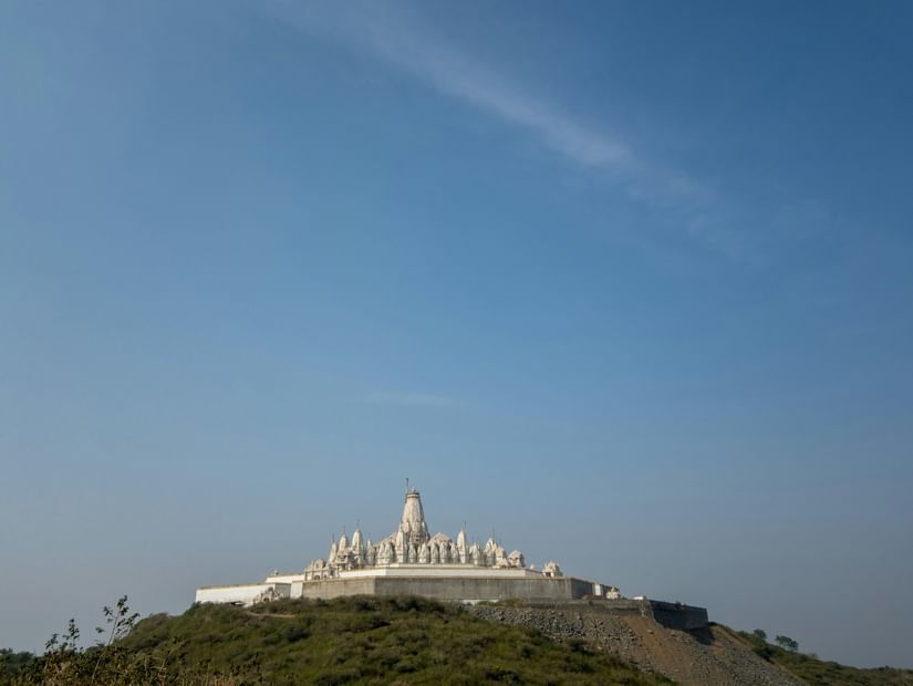 Parasnath Jain Temple on a hilltop as seen from afar with blue sky in the background - Parasnath Jharkhand