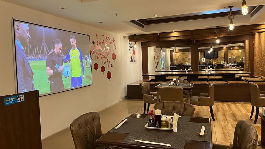restaurant area at Yuhi Mansions showcasing 100 22 LED screen for live sports telecast along with spacious indoor seating arangement3