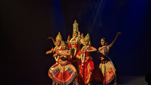 A group of women performing classical Bharatnatyam