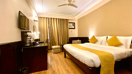 Side view of a bedroom with a wall-mounted television at DLS Park Grace, Haridwar.