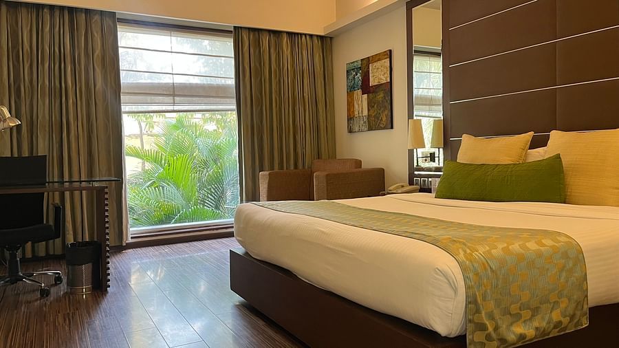 a posh bedroom with luxurious interior along with king size bed soft pillows white linens and the room also features a ceiling-to-floor windows2