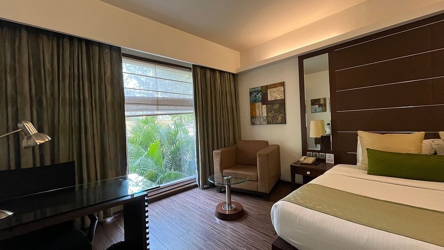 a posh bedroom with luxurious interior along with king size bed soft pillows white linens and the room also features a ceiling-to-floor windows3
