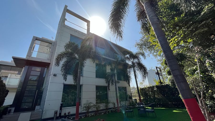 closer view of a hotel building surrounded by green coconut trees and shot from a lower angle with the backdrop of clear blue sky1