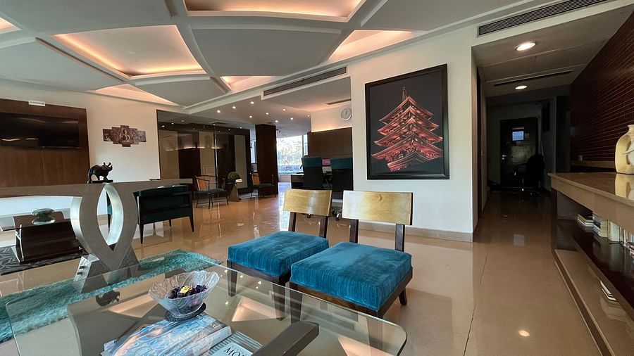 closer view of seating area in the lobby with blue and white theme designed with wall paintings of japanese monuments and figurines kept on tables for beauty3