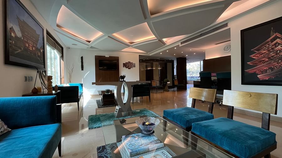 closer view of seating area in the lobby with blue and white theme designed with wall paintings of japanese monuments and figurines kept on tables for beauty4