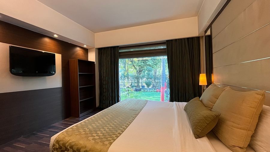 cosy bedroom with luxurious interior and aesthetic lighting where the bed is placed next to floor-to-ceiling window and wooden floor - yuhi mansion Suite Room4
