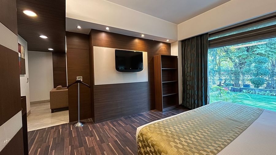 cosy bedroom with luxurious interior and aesthetic lighting where the bed is placed next to floor-to-ceiling window and wooden floor - yuhi mansion Suite Room6