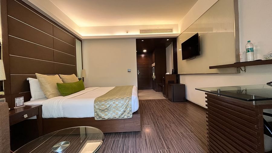 interior of a bedroom with king size bed and room amenities like wardrobe and teapoy - yuhi mansions1 