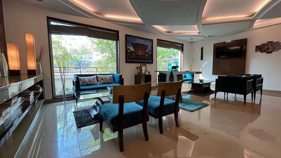 reception and lobby area designed with traditional japanese style consisting of wall paintings and figurines along with large ceiling to floor windows for an aesthetic look4