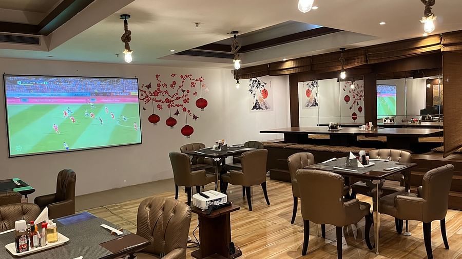 restaurant area at Yuhi Mansions showcasing 100 22 LED screen for live sports telecast along with spacious indoor seating arangement2