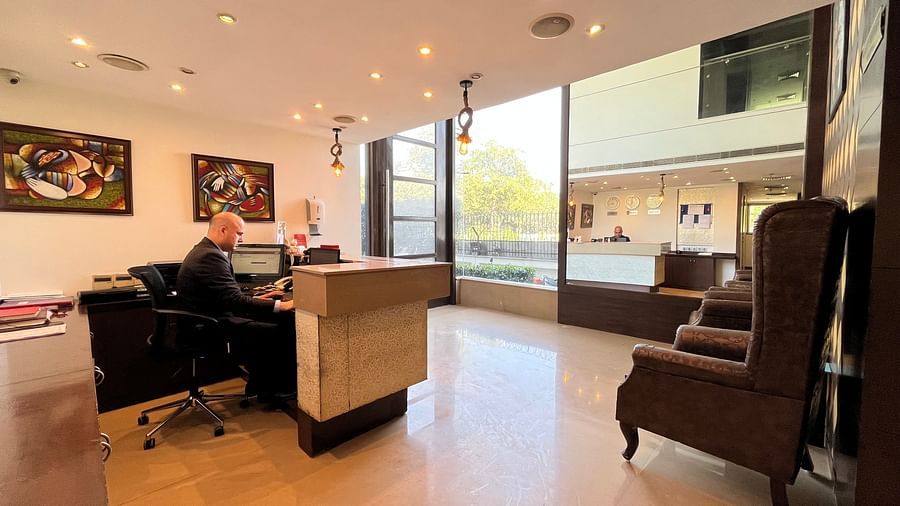 the reception desk at yuhi mansions shot from different angles showcasing a staff working while wearing a suite3