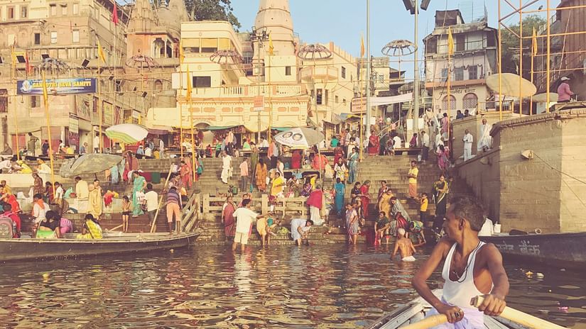 A photo of a man riding the boat in The Ganga