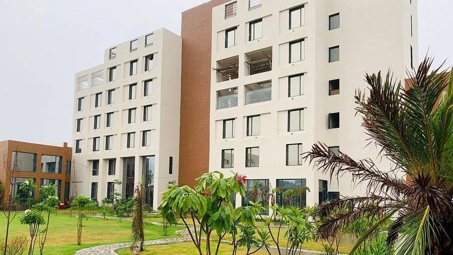 Image of the Facade of Pride Resort Ambaji  taken from it's garden hence a little bit of the garden is visible too