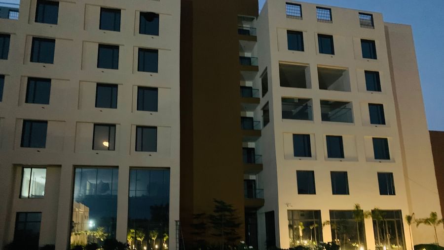 Image of the Facade of Pride Resort Ambaji  taken from it's garden hence a little bit of the garden is visible too