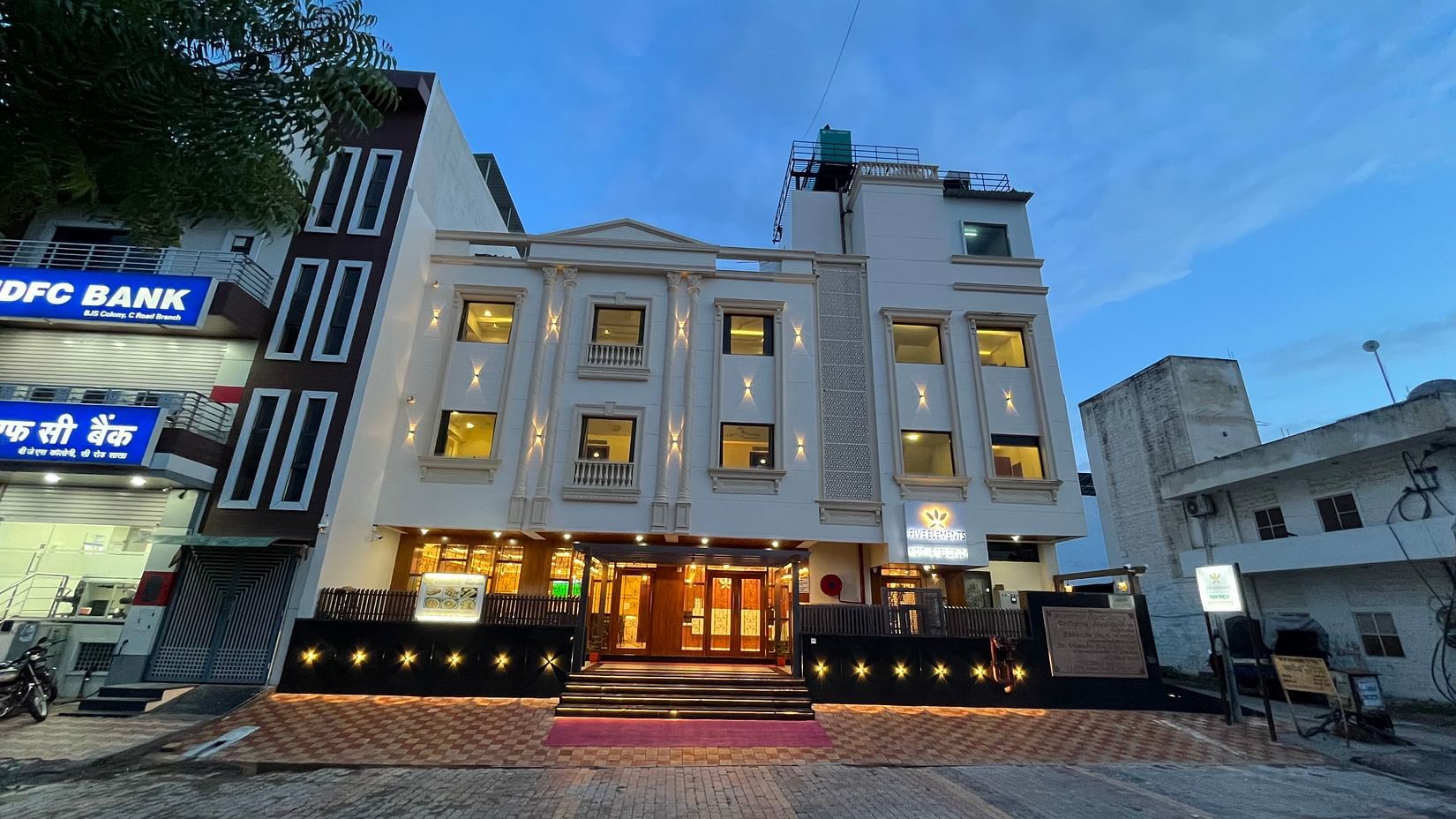 An image of a well lit facade of Five Elements Hotel, Jodhpur which also has buildings on either side