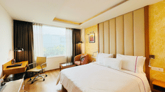 Comfortable standard room at Nemesia with a king size bed, a work desk, and a view of the outdoors.