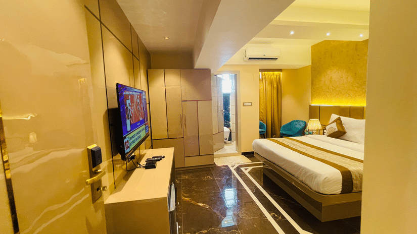 A TV on the wall and bed in a bedroom | Home2 Renaissance Club Hotel
