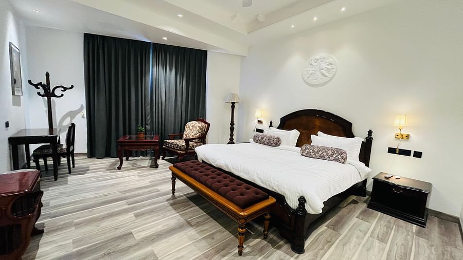 an image of a bedroom with a long blackout curtains at Clarks Resort The Archi’s Castle, Ajmer