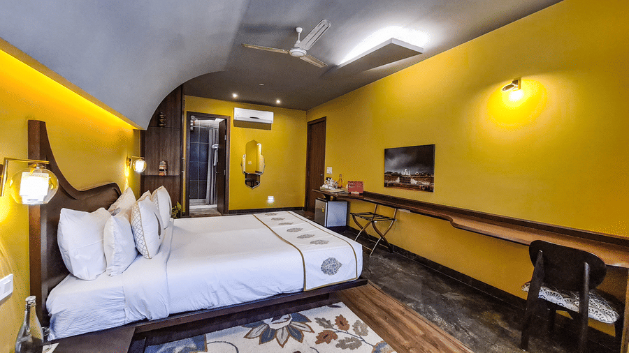 A bedroom at Ekaa Agra with a neatly-made bed, work desk, and contemporary interiors.