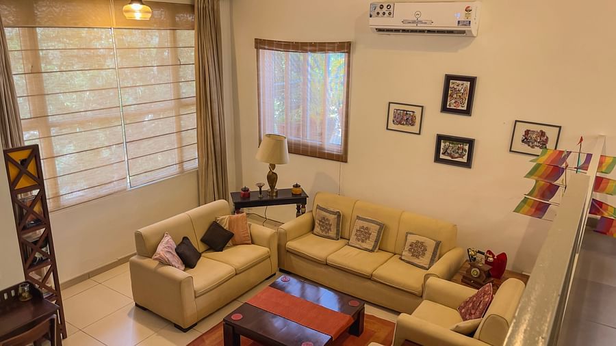Sofas and ac mounted on the wall inside the living room at El Benito Goa