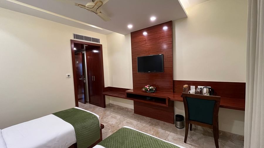 An image of Deluxe Twin room featuring twin beds, a work desk and chair, and a flat TV screen at Five Elements Hotel, Jodhpur