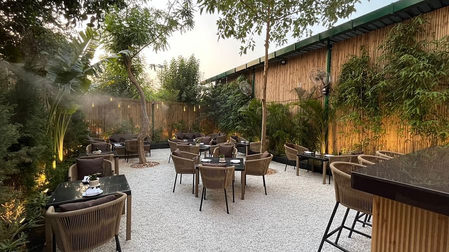Nemesia provides a patio with tables and chairs arranged for outdoor dining.