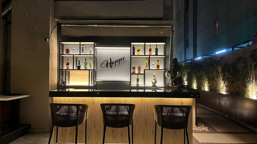 Nemesia's bar area features seating and a counter with shelving behind.