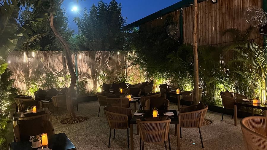 At Nemesia, an outdoor seating area is lit with soft lighting at dusk.