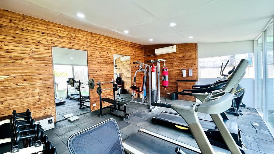 Well-equipped fitness center at Nemesia with modern exercise equipment including treadmills, weight machines, and cardio equipment.