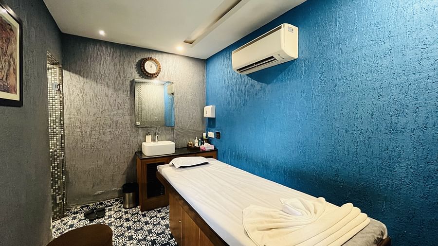 Massage room at Nemesia with a comfortable massage table and soothing painted walls.