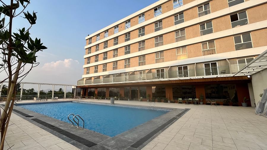 Outdoor swimming pool with an open sky view at VITS Satyajeet Karad