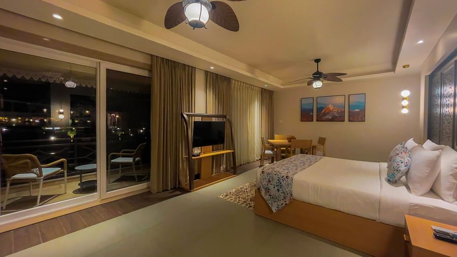 A large bed room with a dining area having a separate balcony.