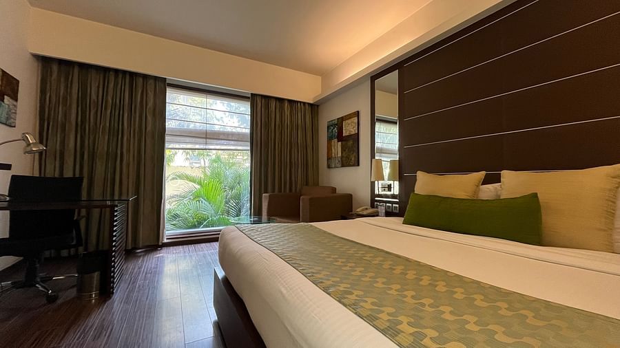 a posh bedroom with luxurious interior along with king size bed soft pillows white linens and the room also features a ceiling-to-floor windows4