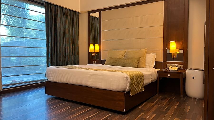 cosy bedroom with luxurious interior and aesthetic lighting where the bed is placed next to floor-to-ceiling window and wooden floor - yuhi mansion Suite Room1
