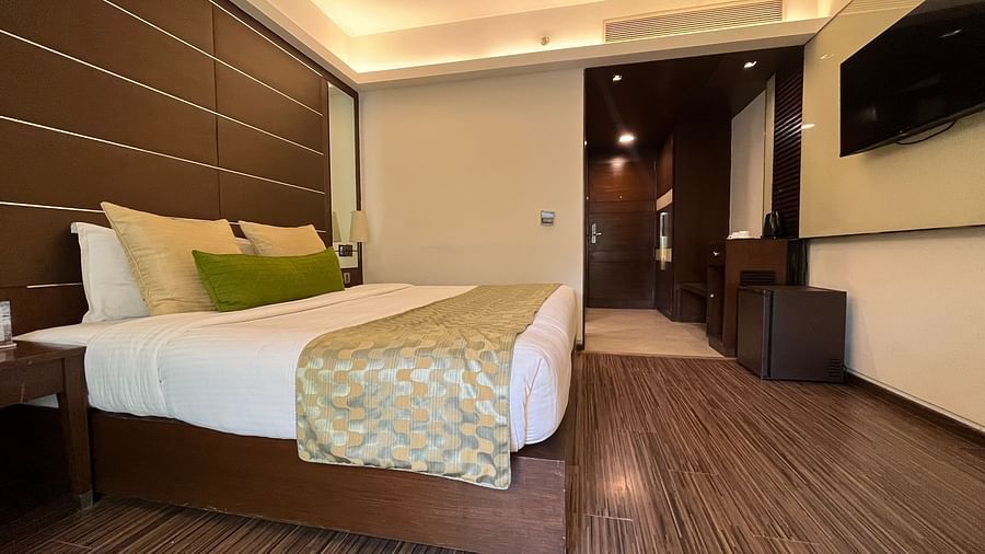 interior of a bedroom with king size bed and room amenities like wardrobe and teapoy - yuhi mansions2