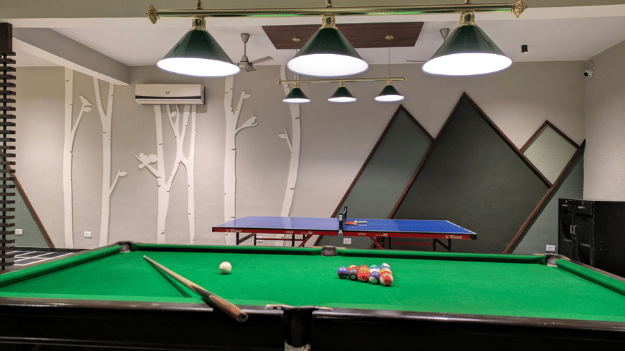 An indoor room featuring a  felt pool table and a  ping pong table at The Golden Tusk, Jim Corbett