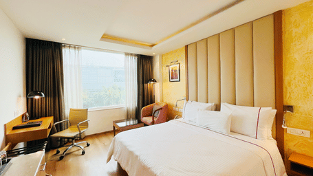 Comfortable standard room at Nemesia with a king size bed, a work desk, and a view of the outdoors.