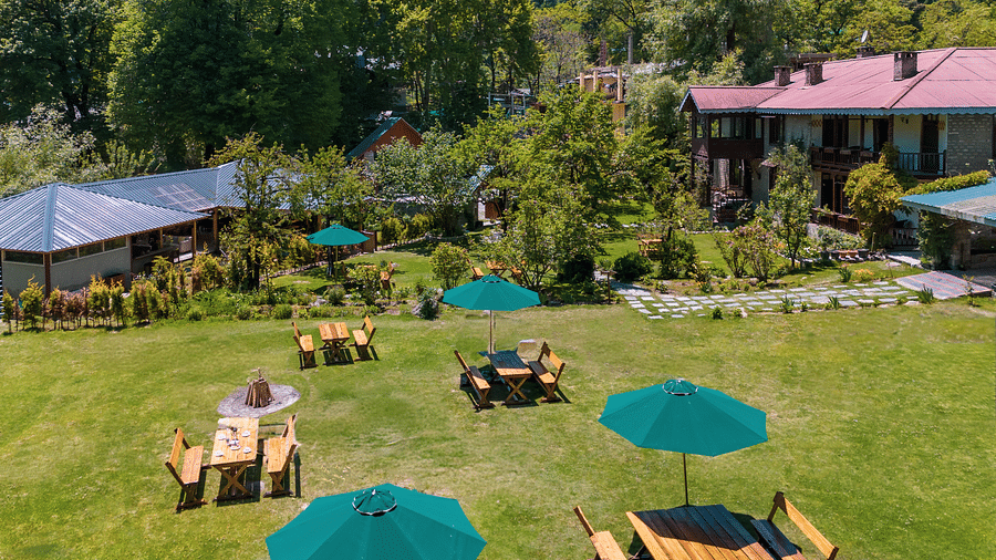 aerial side view of facade of Bedzzz Xclusiv Baikunth, Manali with outdoor seating arrangements