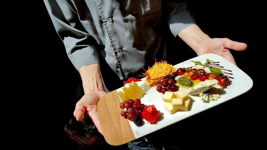 A chef presenting a beautifully plated dish with care - Brewery Gulch Inn & Spa