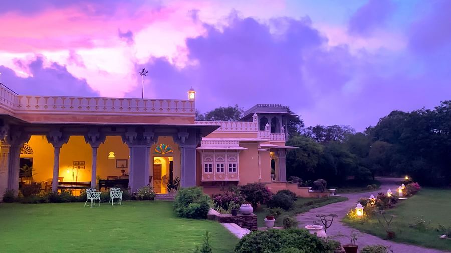 Facade image of Dev Shree, Deogarh featuring a beautiful Sunset with pink and lavender hues in the background