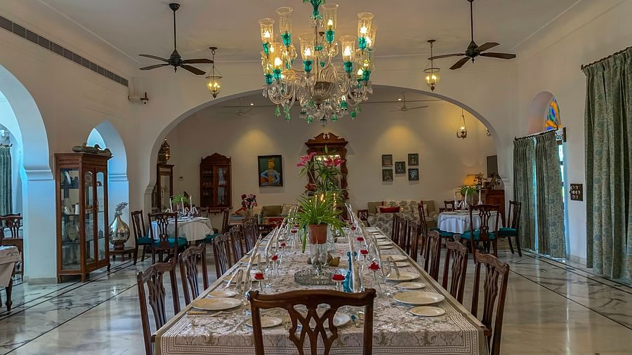 image featuring a long dinner table with neatly placed cutlery at Dev Shree, deogarh