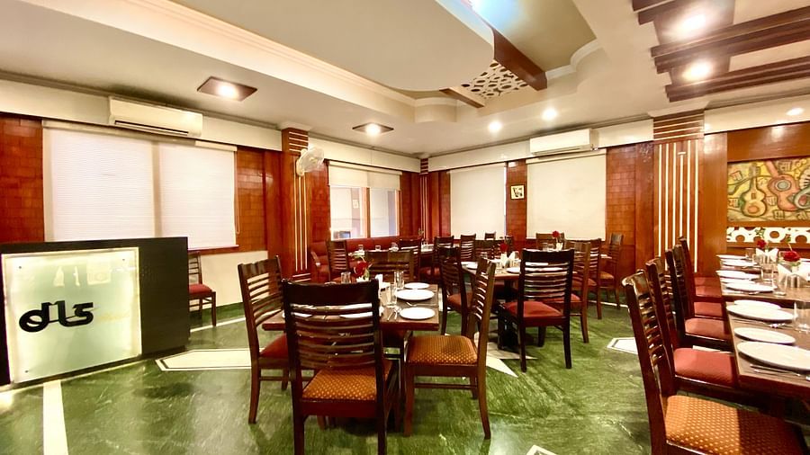 IA spacious restaurant interior with multiple tables and chairs arranged in rows  | DLS Park Grace, Haridwar