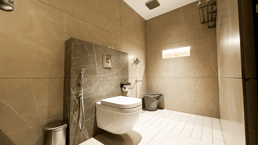 Full view of a brightly lit bathroom at the Deluxe Room at F Hotels, Bengaluru.