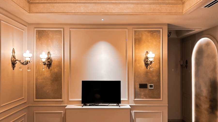 Front view of the television kept on a table with paneled walls in the Presidential Suite of F Hotels, Bengaluru.