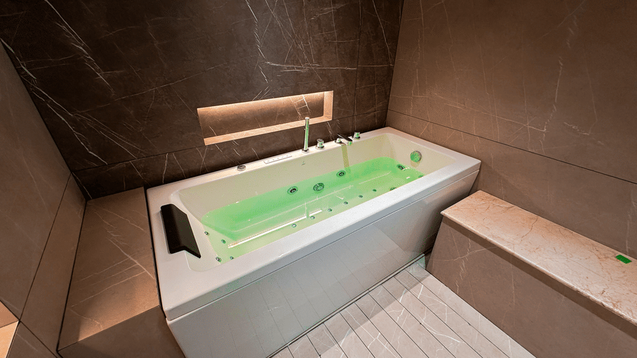 Top view of the full-length bathtub filled with water in the bathroom of the Presidential Suite at F Hotels, Bengaluru.