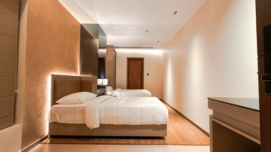 Side view of the twin beds in a sleek and modern Superior Room at F Hotels, Bengaluru.