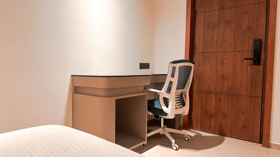 Close up of the work station besides a wooden door at the Superior Room at F Hotels, Bengaluru.