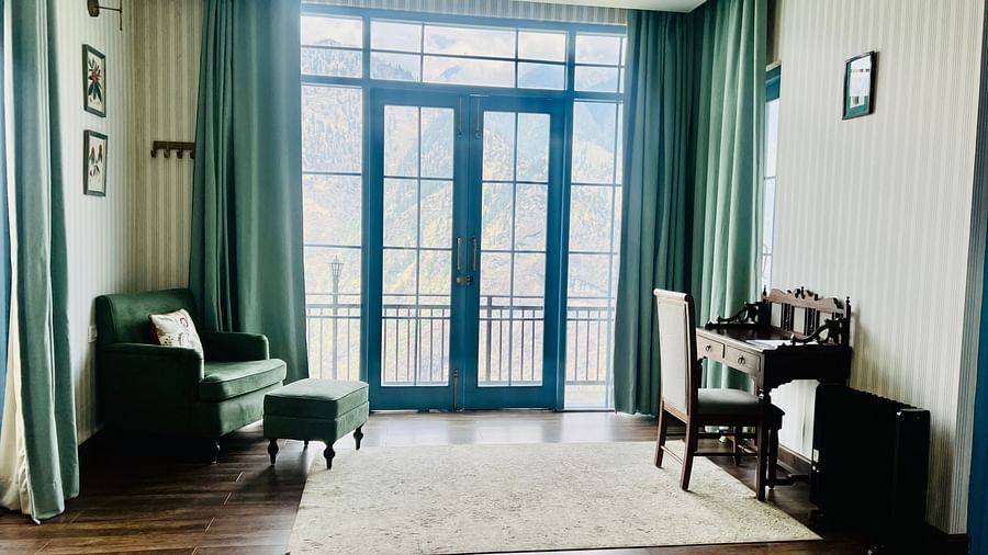 An entrance of a property where two chairs are placed on each side | Faraway Cottages, Auli